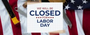 We will be closed on Labor Day. The words appear on grid paper in front of an American Flag.